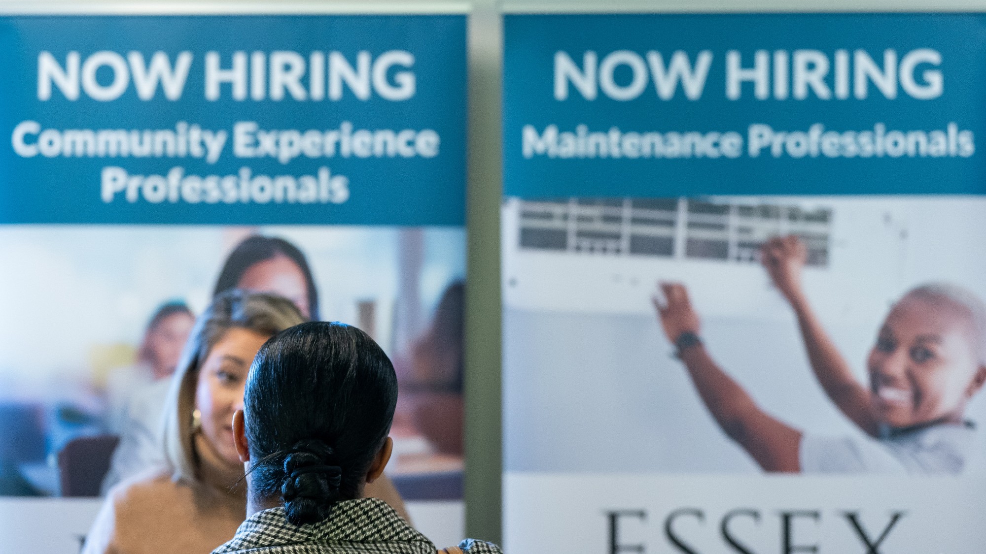 A woman talks to a recruiter at a Seattle job fair