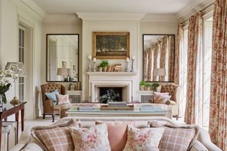 Sofa with pillows in foreground of living room with antiques