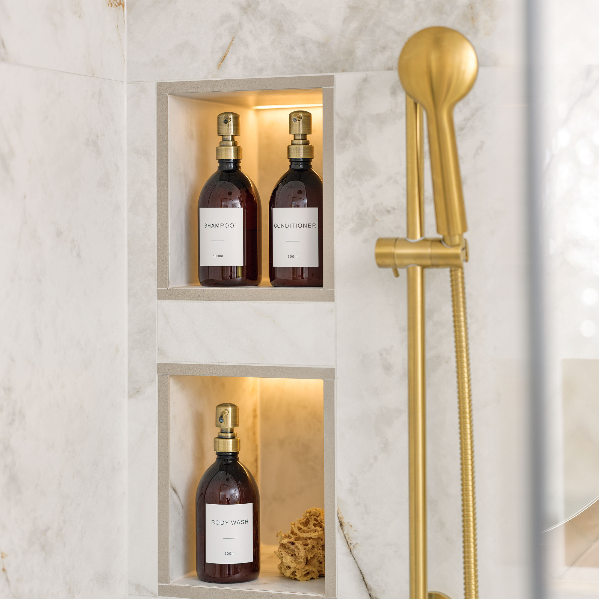 White bathroom with built in shelves and gold shower