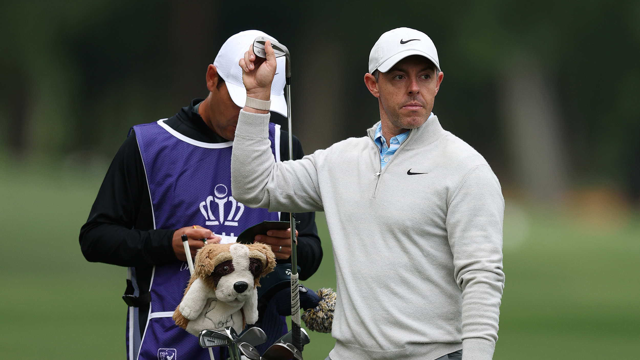 Rory McIlroy pulls a club out of his bag