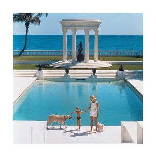 American writer C.Z. Guest (Mrs F.C. Winston Guest, 1920 – 2003) and her son Alexander Michael Douglas Dudley Guest in front of their Grecian temple pool on the ocean-front estate, Villa Artemis, Palm Beach