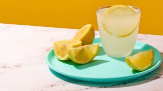 Cloudy lemonade sitting on tray with lemon wedges