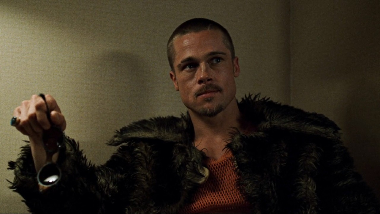 Brad Pitt in Fight Club holding sunglasses in his left hand.