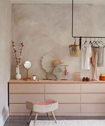 Ikea chest of drawers painted in pale pink and topped with wooden plank