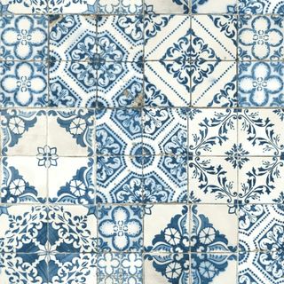 A blue and white tiled pattern peel and stick wallpaper