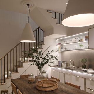 white kitchen with staircase lighting and illuminated shelving