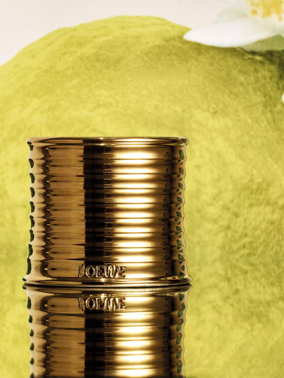 A ribbed gold Loewe candle with an earl grey fragrance