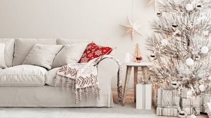 white living room with a white christmas tree and red accents