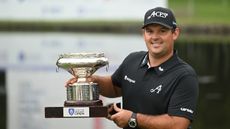 Patrick Reed smiles while holding up the Asian Tour's Hong Kong Open trophy