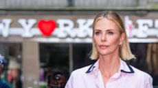 charlize theron wearing a pink shirt 