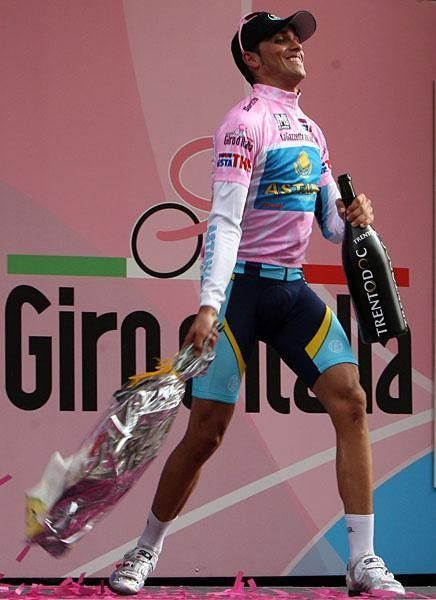 Alberto Contador tosses the bouquet after getting his third pink jersey.