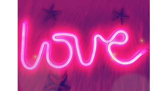 A neon pink light spelling out the word love