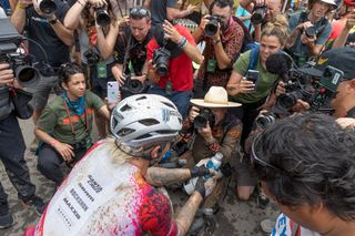 Keegan Swenson surrounded by cameras after winning the 200-mile Unbound Gravel race in 2023.