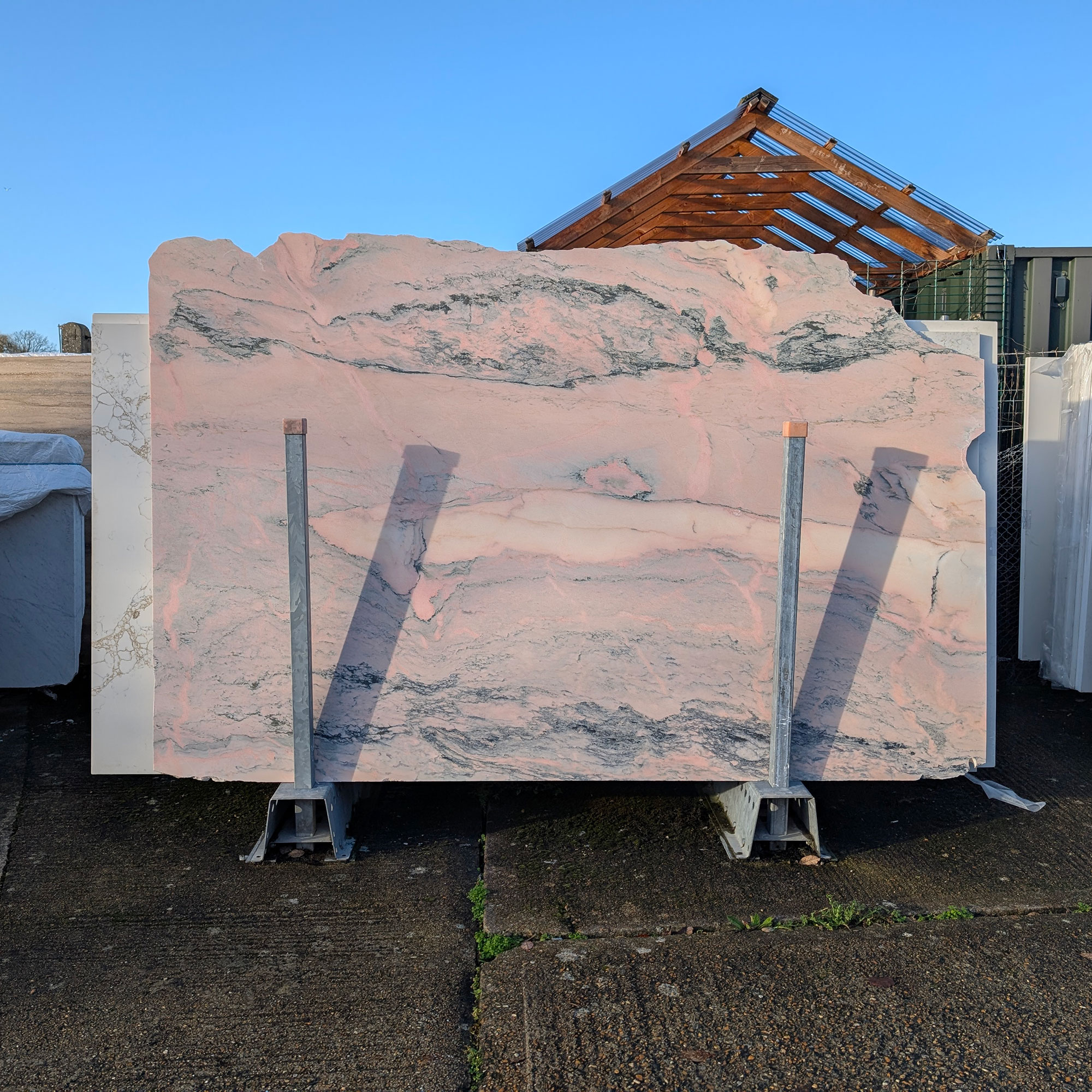 Large slabs of stone outside in warehouse yard