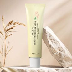 An image of AXIS-Y Brightening Cream on beige rick and background
