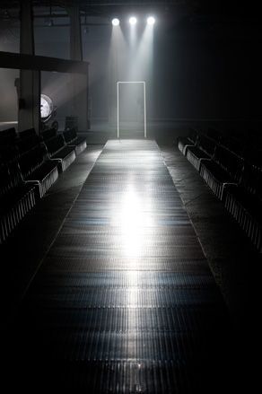 Etienne Russo and his team placed a thin neon door to light the models' entrance over the black rubber catwalk