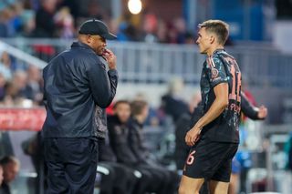 Kiel, Germany - September 14: head coach Vincent Kompany of Bayern Muenchen and Joao Palhinha of Bayern Muenchen talk together during the Bundesliga match between Holstein Kiel and FC Bayern München at Holstein Stadium on September 14, 2024 in Kiel, Germany. (Photo by Marco Steinbrenner/DeFodi Images via Getty Images)