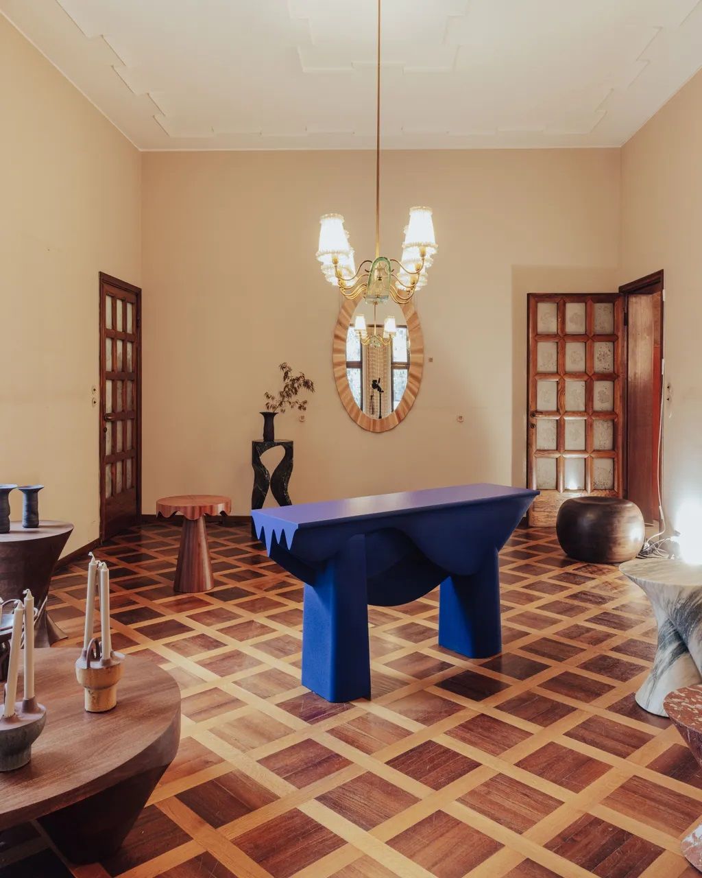 A design installation features a series of sculptural furniture items and objects.