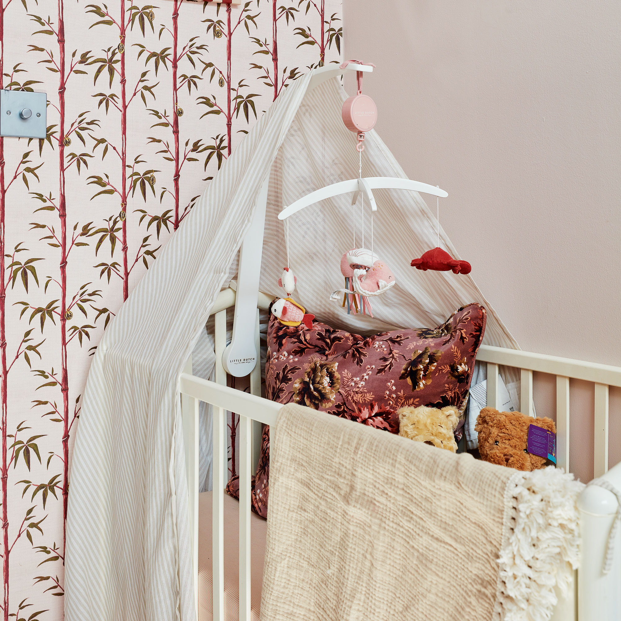 Cot in nursery with a canopy
