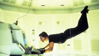 Tom Cruise's Ethan Hunt hangs from wires as he hacks a computer in Mission: Impossible