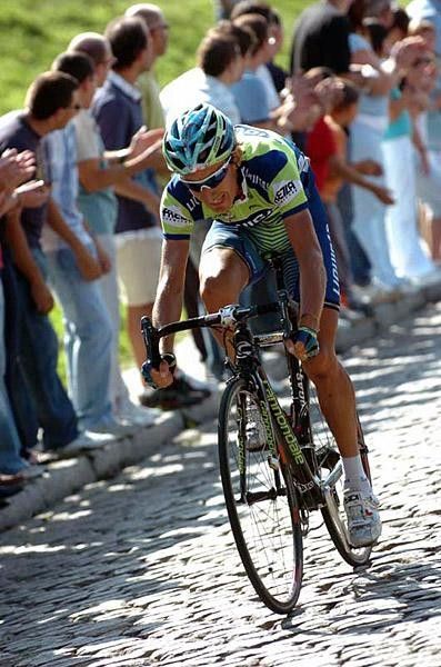 Riders pass the fortified city wall of Avila