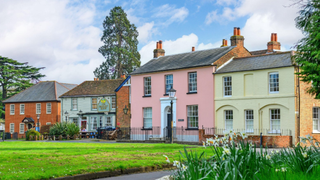 Pink period house in Surrey overlooking a village green.