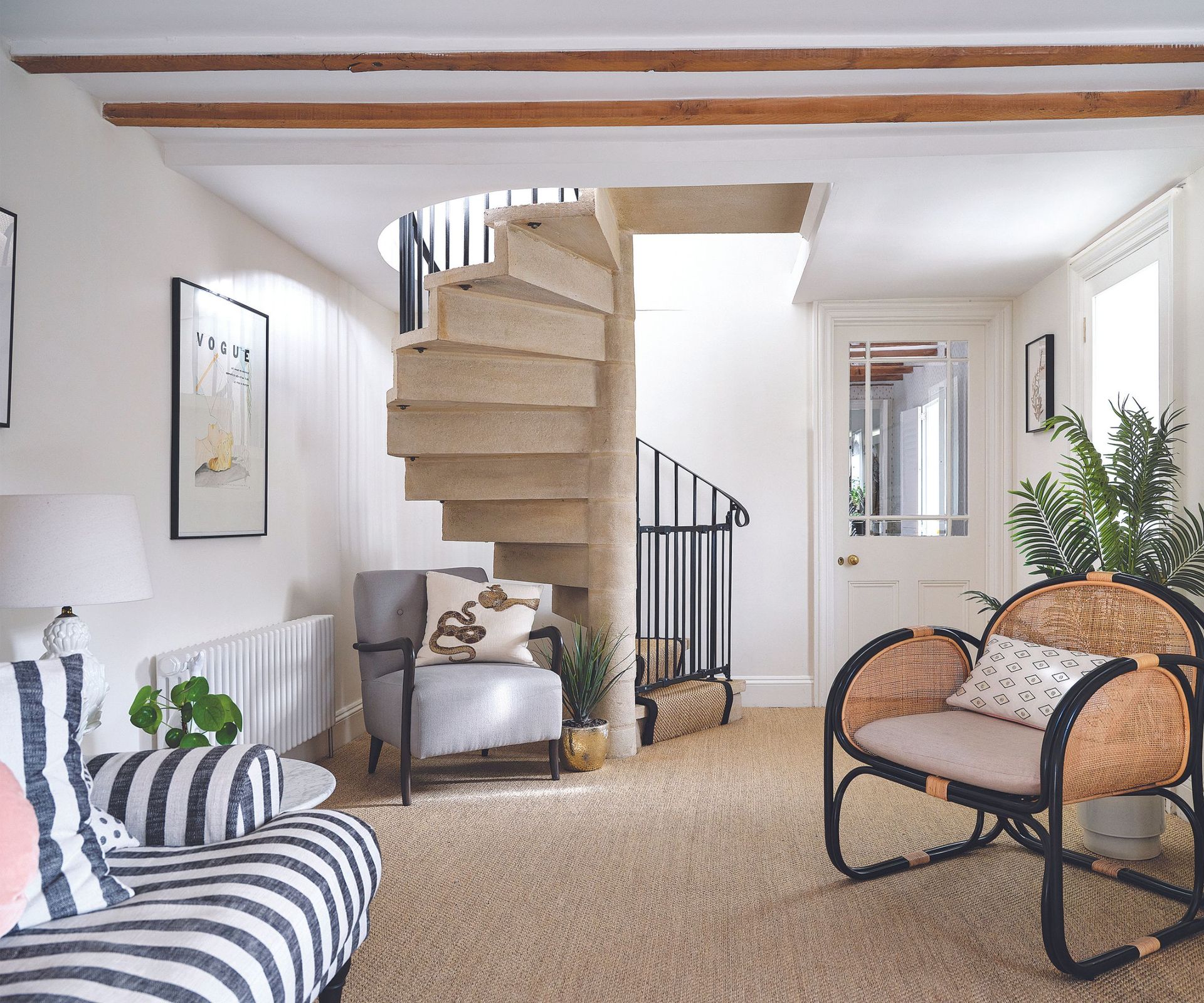 Spiral stairs, black banister, wooden chair