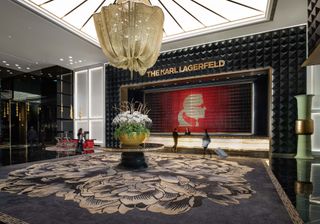 The Karl Lagerfeld Macau hotel entrance lobby with chandelier and profile of the designer
