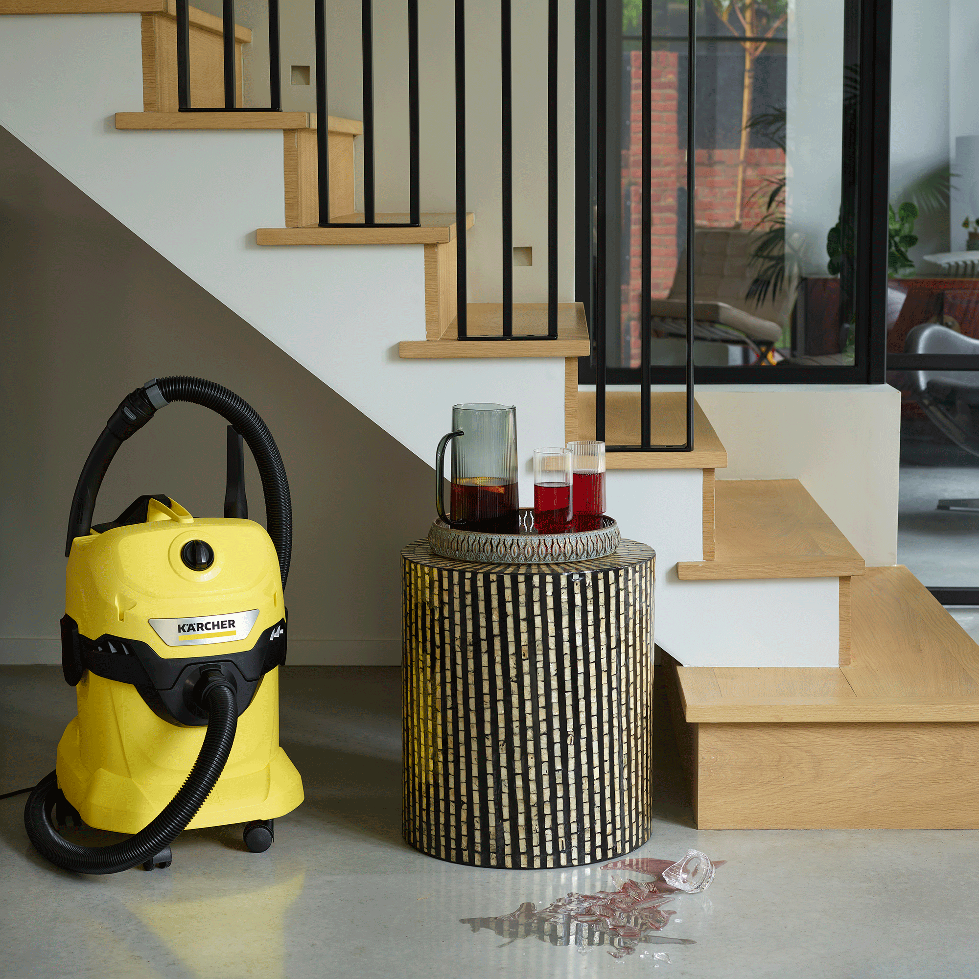 Karcher wet and dry vacuum cleaner in hallway with glasses