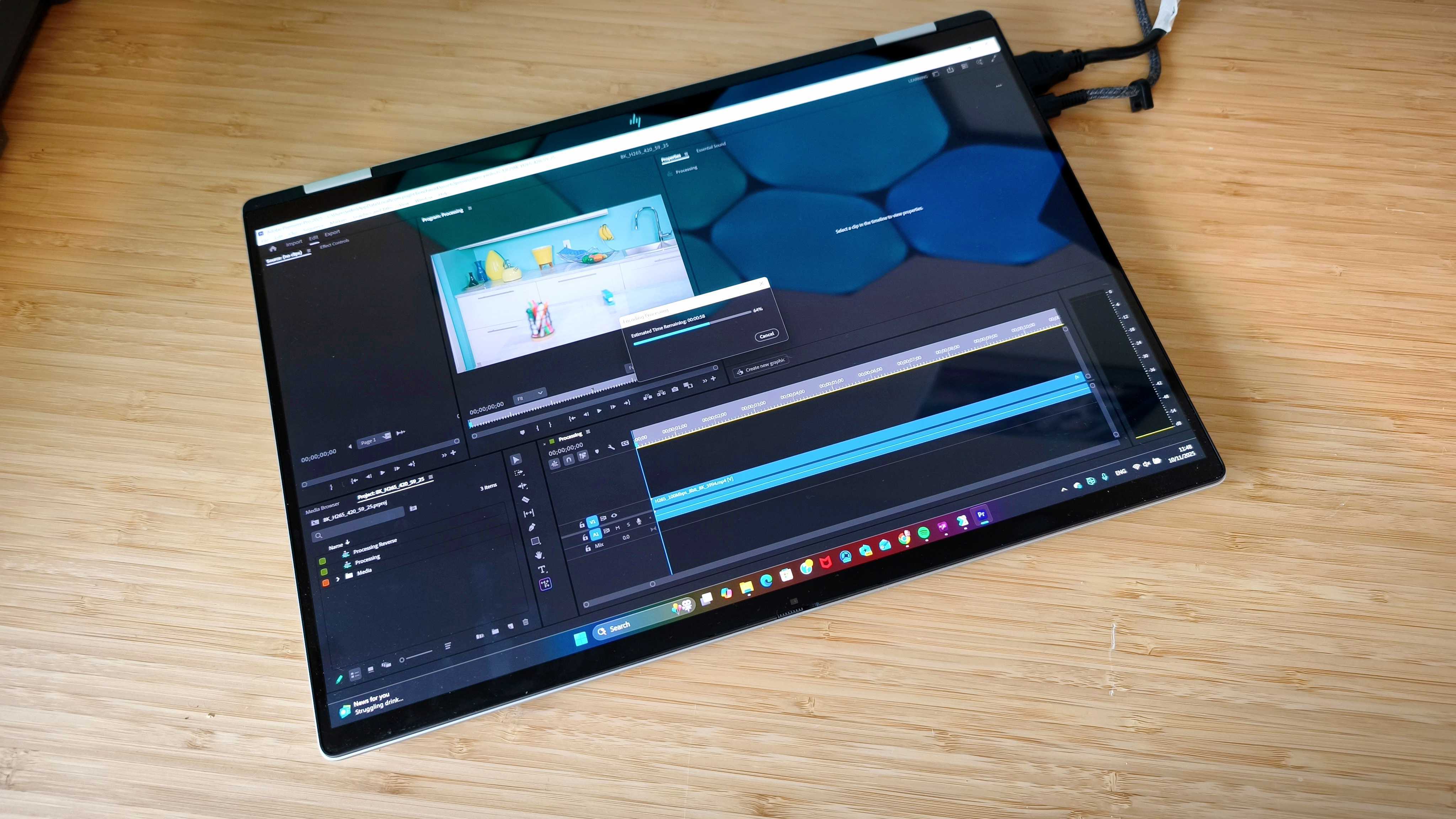 A silver HP Omnibook X Flip 16 2-in-1 laptop on a wooden desk