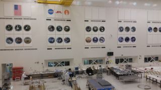 The spacecraft assembly building includes an enormous clean room (hence the workers wearing white clean-room suits) that hosts multiple projects.
