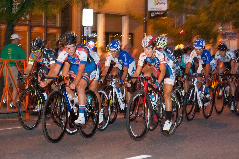 An ISCorp rider leads the women's field through the streets of Littleton.