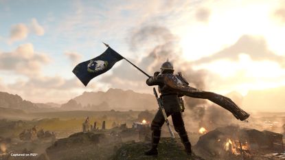 A Helldiver waves a flag while looking down at a battlefield in a screenshot from Helldivers 2's Masters of Ceremony trailer.