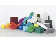 Kvadrat textiles on a stack of upholstered abstract shapes showing the chromatic variety