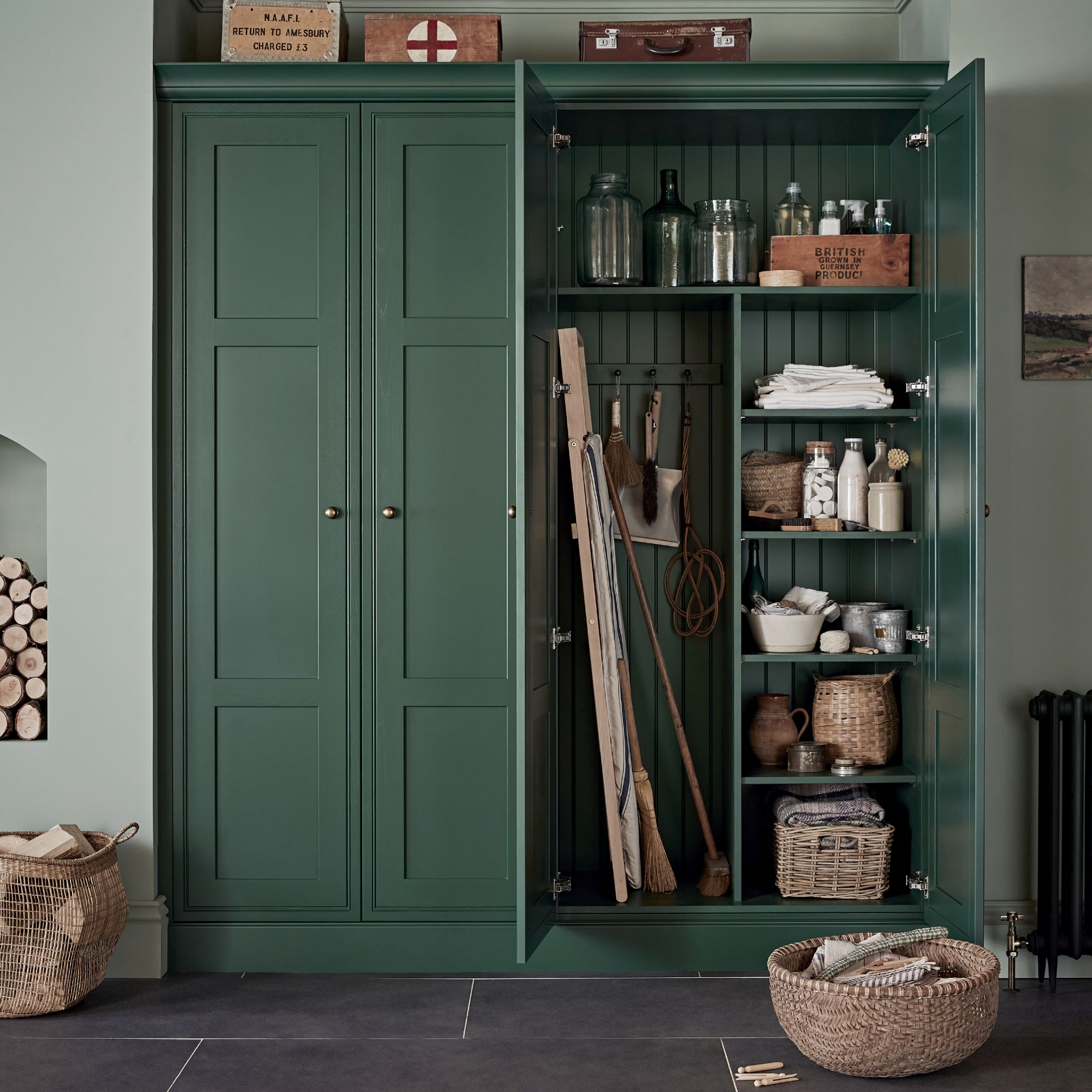 utility room colour ideas, green utility style cabinet, green walls, stone tiles