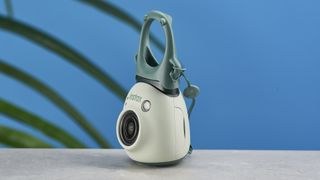 A pistachio green Fujifilm Instax Pal digital camera