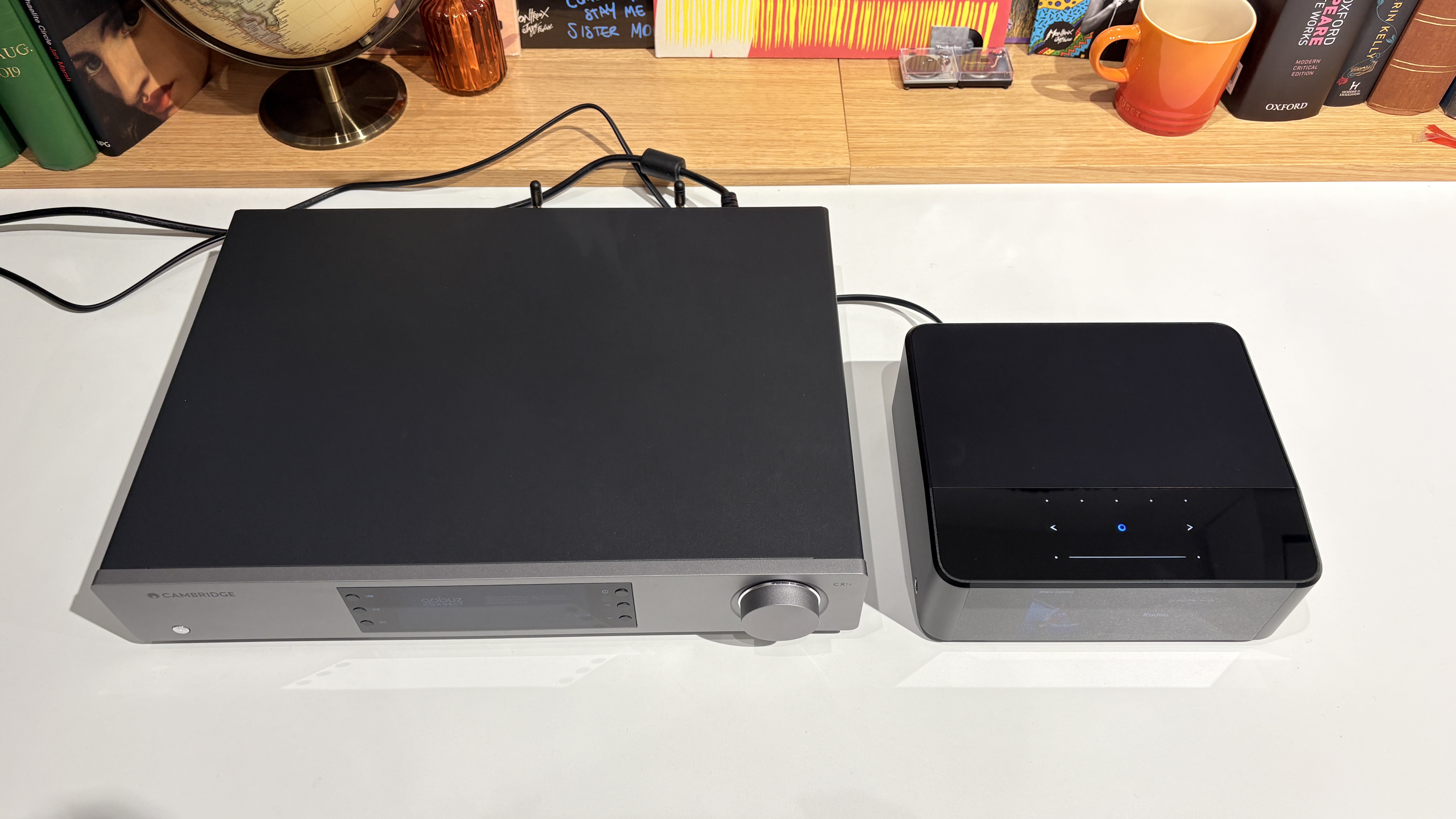 Bluesound Node Icon and Cambridge Audio CXN100 streamers placed next to each other on a white desk