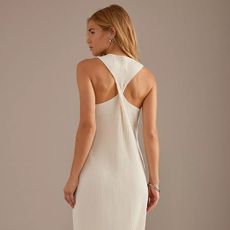 Woman in white dress with back twist detail