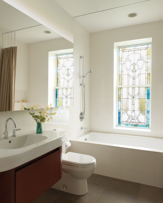 A bathroom with stained glass windows