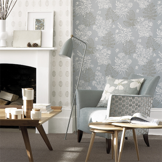 living area with fireplace and arm chair and grey wall