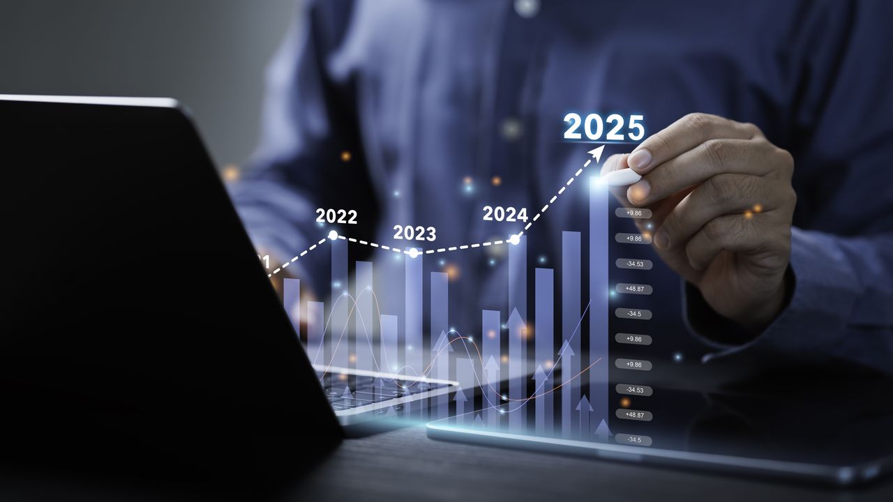 Businessman analyses the graph of trend market growth in 2025