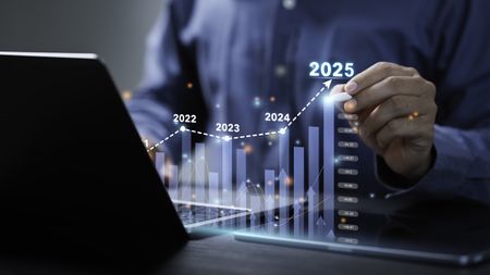 Businessman analyzes the graph of trend market growth in 2025