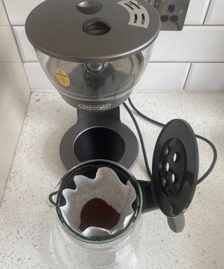 Putting ground coffee into the De'Longhi Clessidra coffee maker