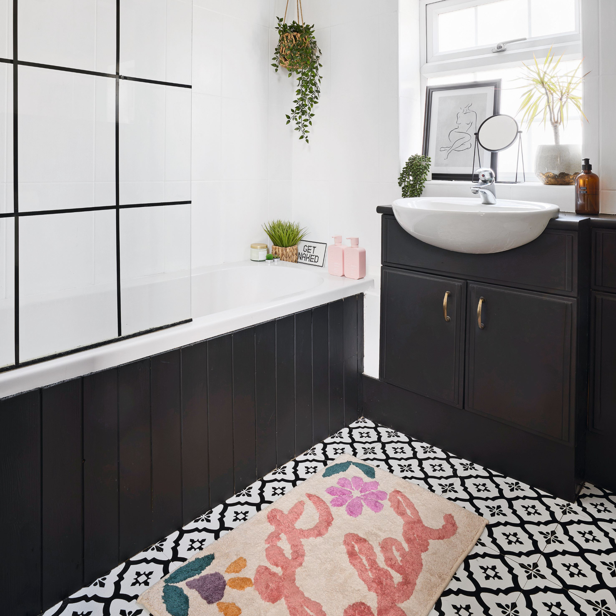 Bathroom with tiled floor and pink coloured bath mat