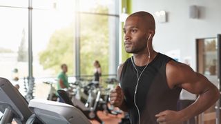 Man listening to music on a treadmill