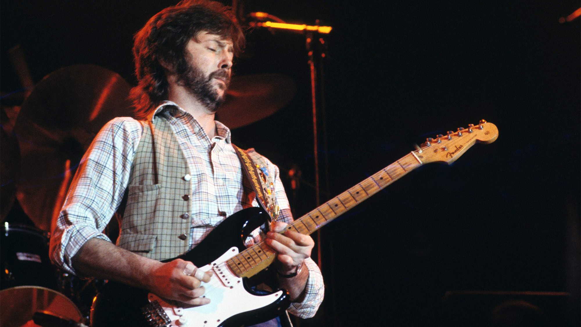 Eric CLAPTON; performing live onstage, playing Fender Stratocaster guitar 'Blackie'
