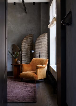 A cozy corner with grey wall
