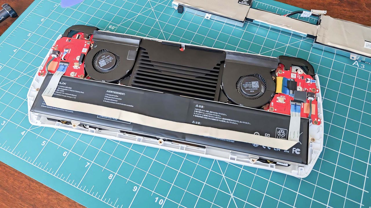 The battery from the JSAUX ROG Ally Battery Upgrade Kit fully installed in the open Ally.