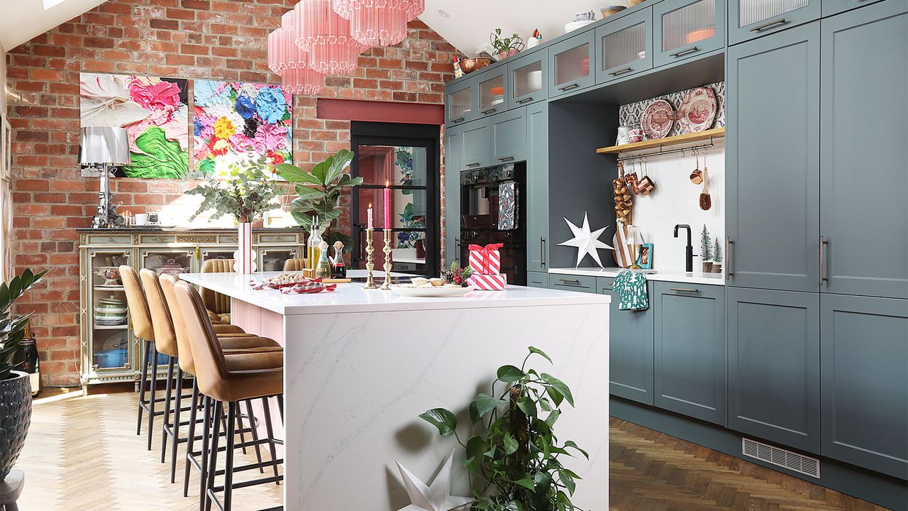 grey kitchen with white island and pink light pendants