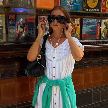Creator @rebeccaferrazwyatt wearing a white dress and green jumper with glowing skin